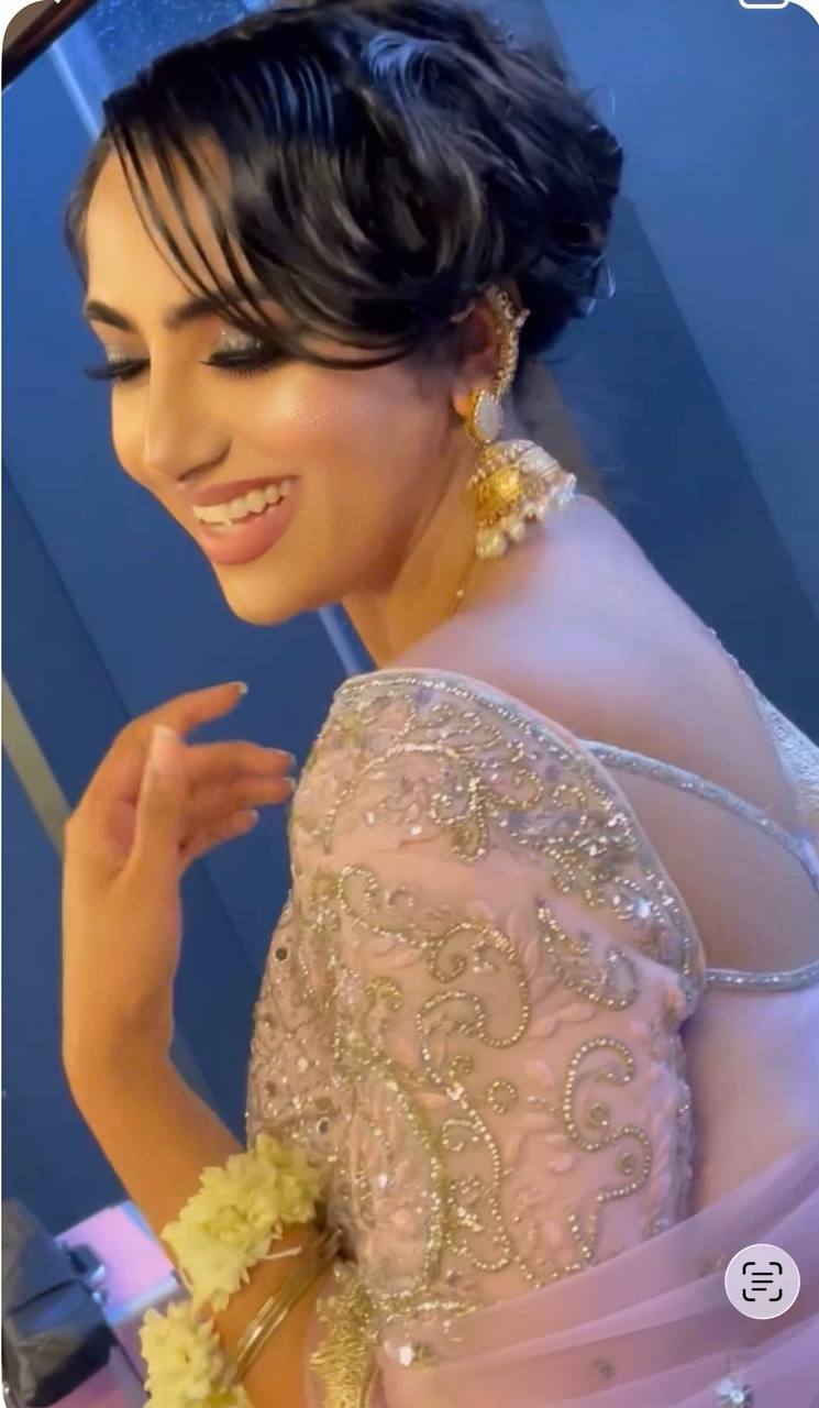 South Asian bride, soft light, laughing — a beauty moment